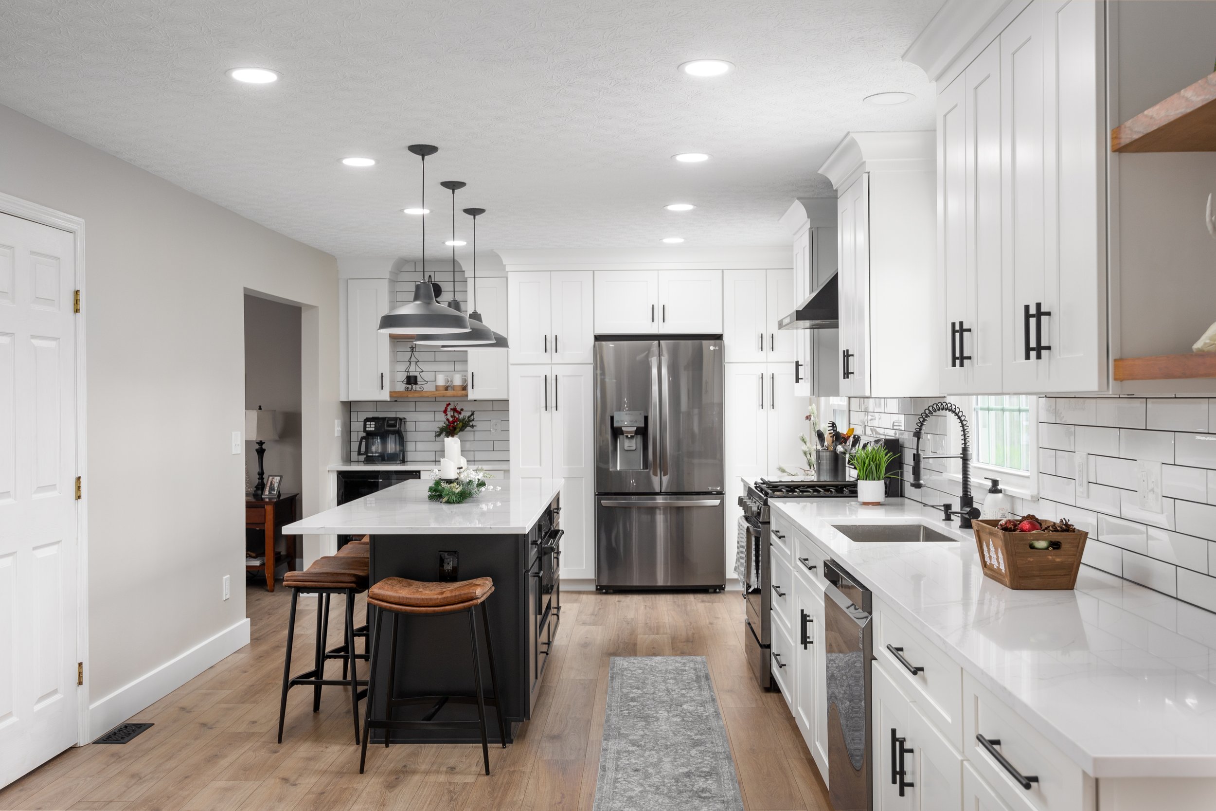 Hilliard kitchen in a black and white palette with contrasting cabinetry and counters
