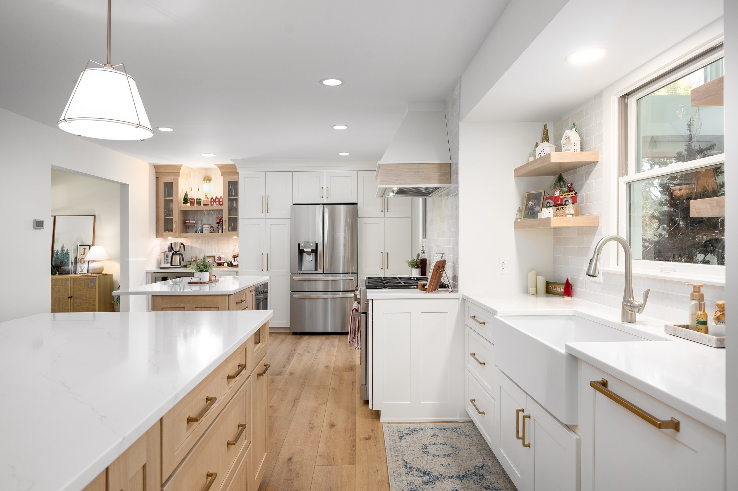 Waterford Village kitchen with light cabinetry and a full-height tiled range wall