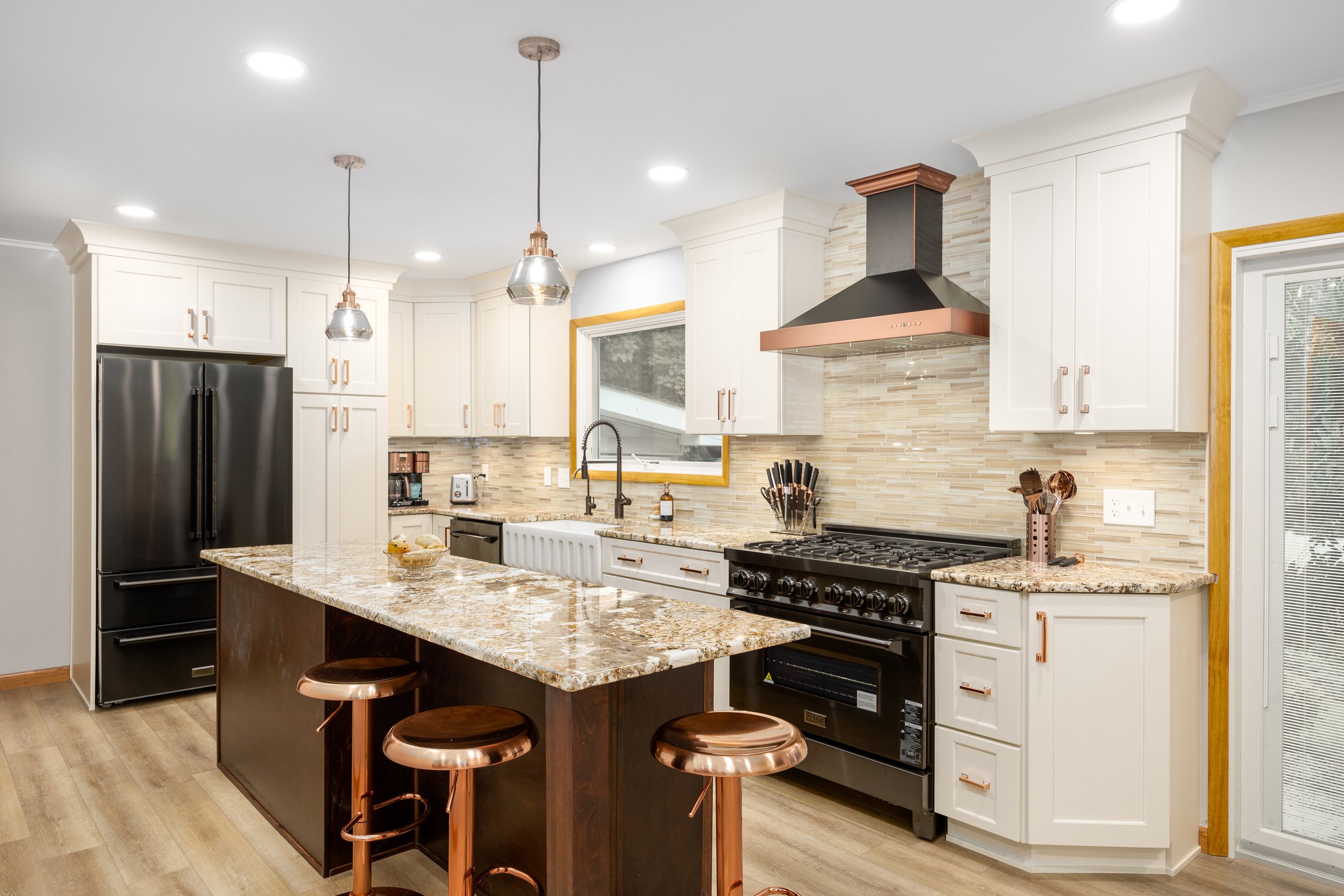 Westerville kitchen with painted perimeter cabinetry and a custom stained wood island